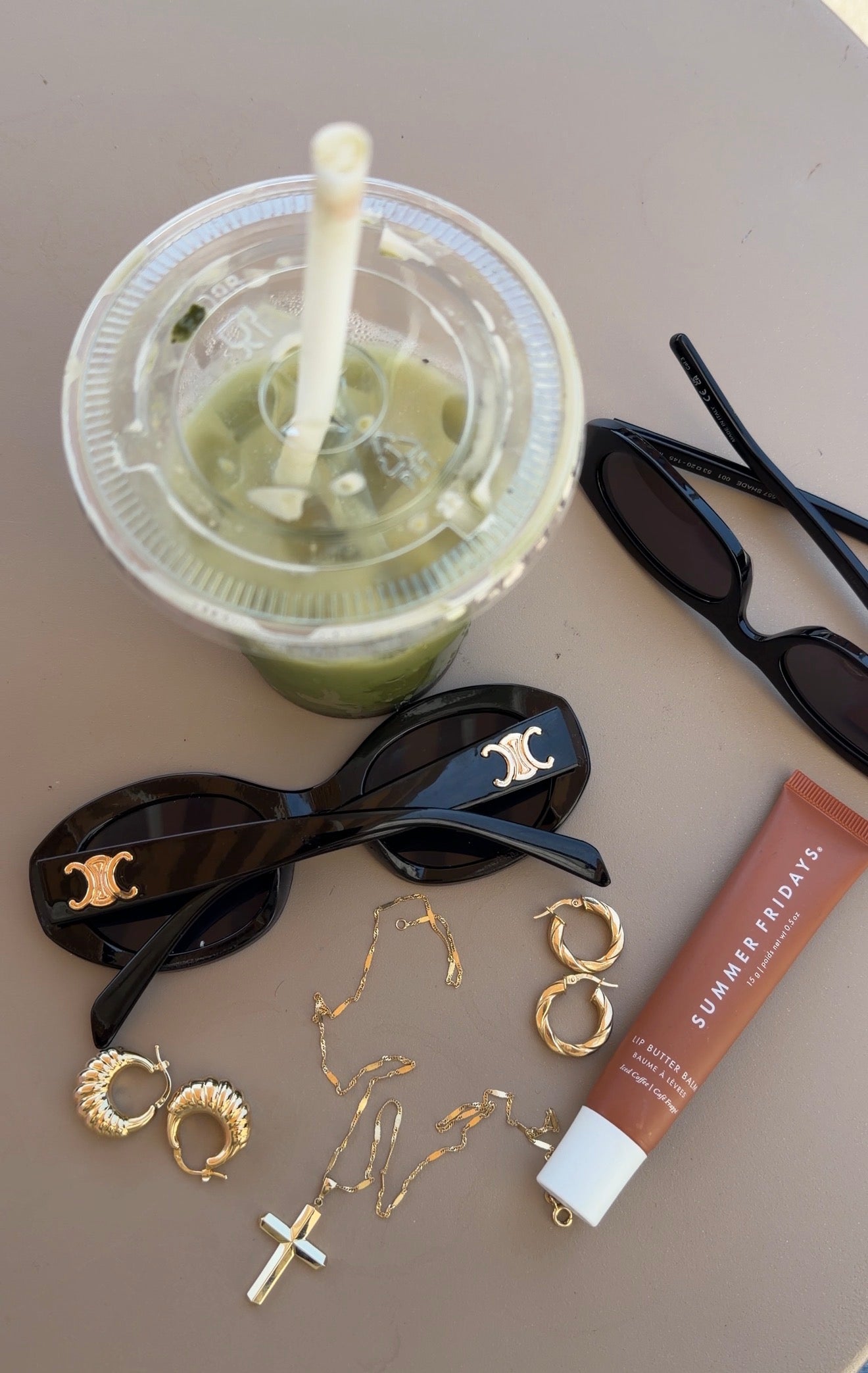 everyday lifestyle flat lay featuring senoe solid gold jewelry