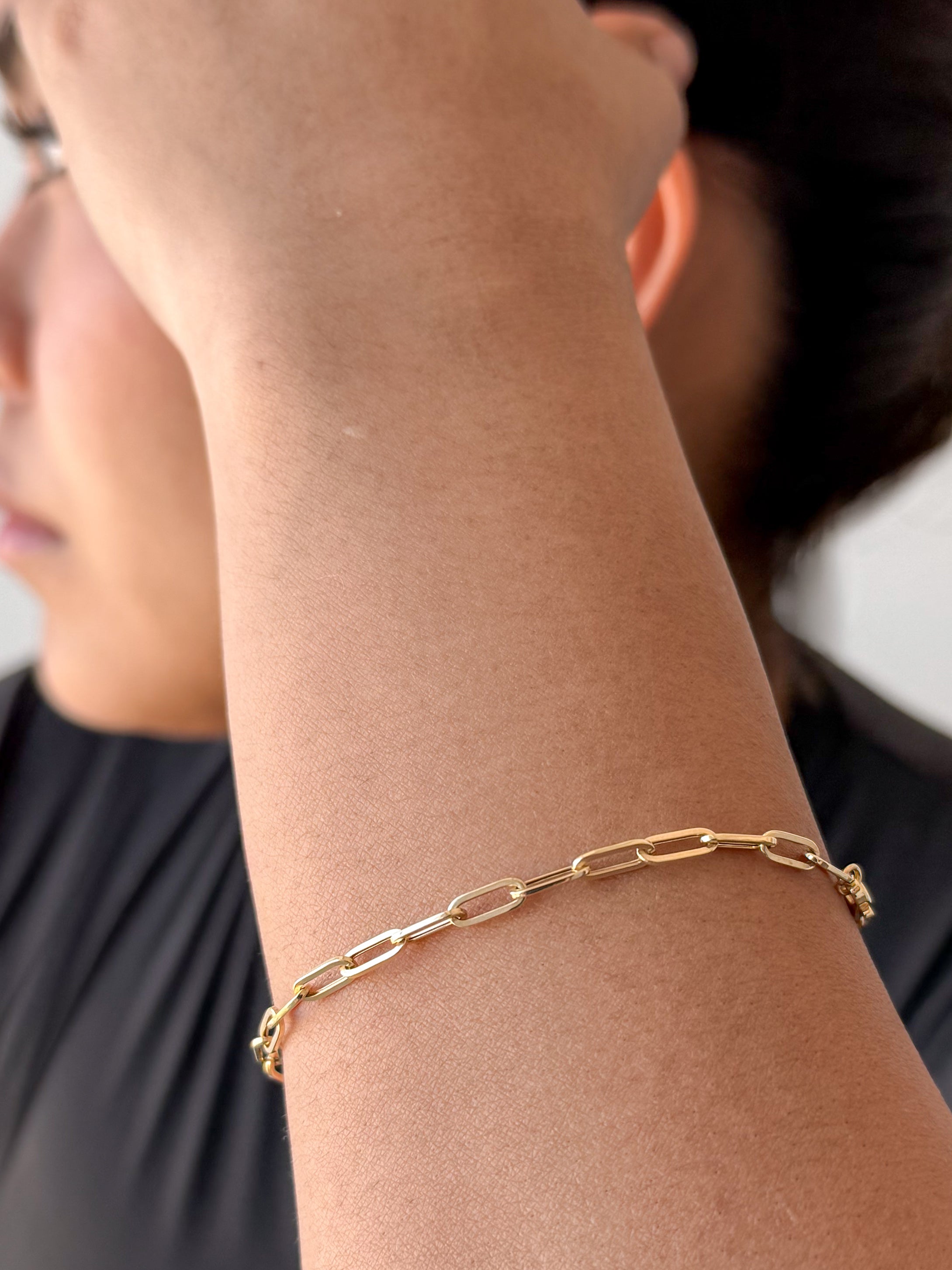 senoe 10k yellow gold paperclip bracelet worn on the wrist 