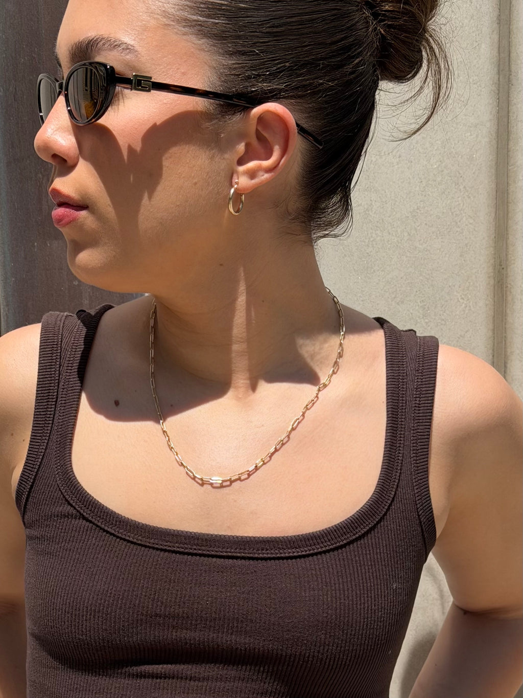 model wearing senoe classic hoop earrings in 10k yellow gold