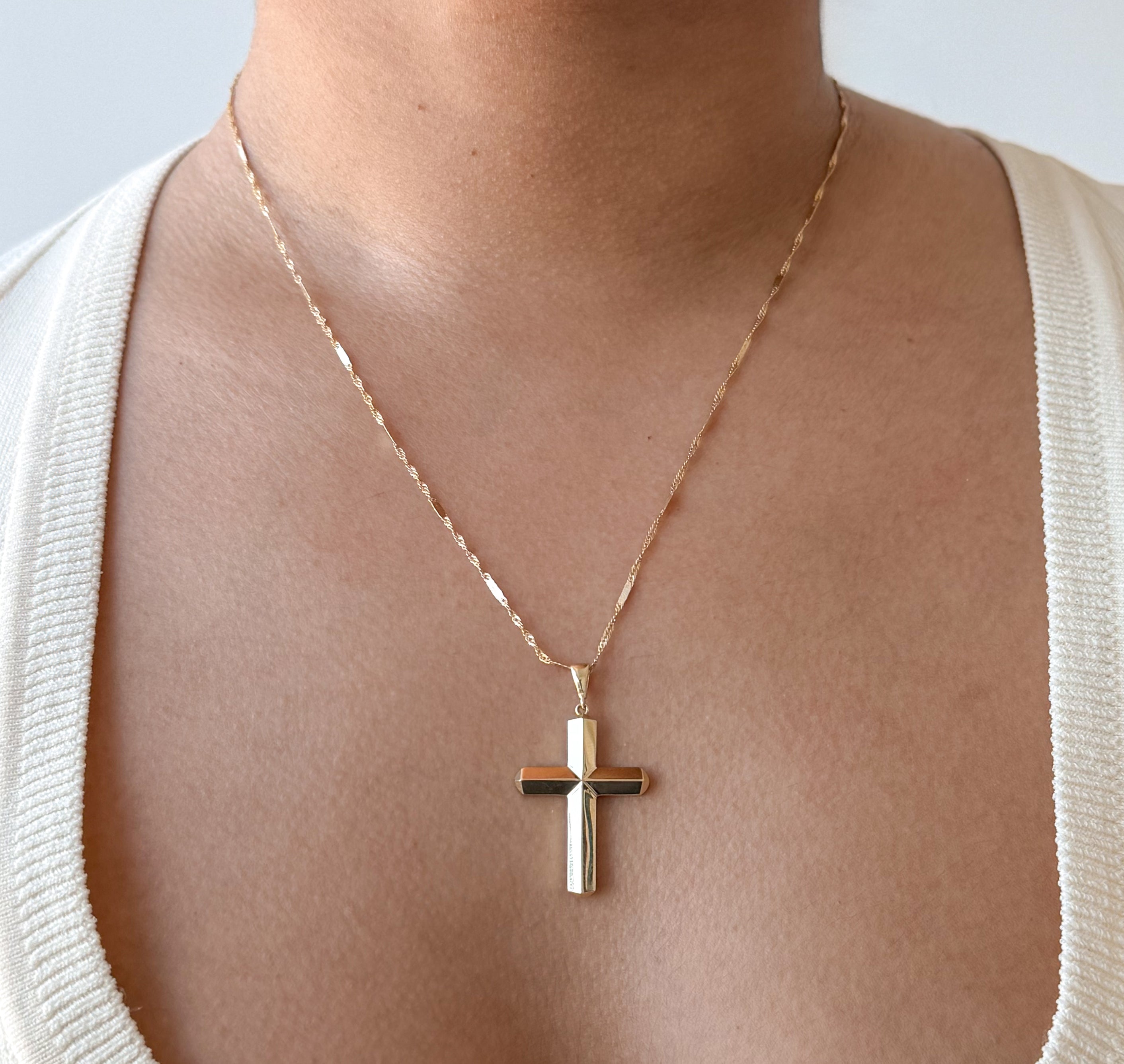 model wearing senoe gold cross pendant in 10k yellow gold 