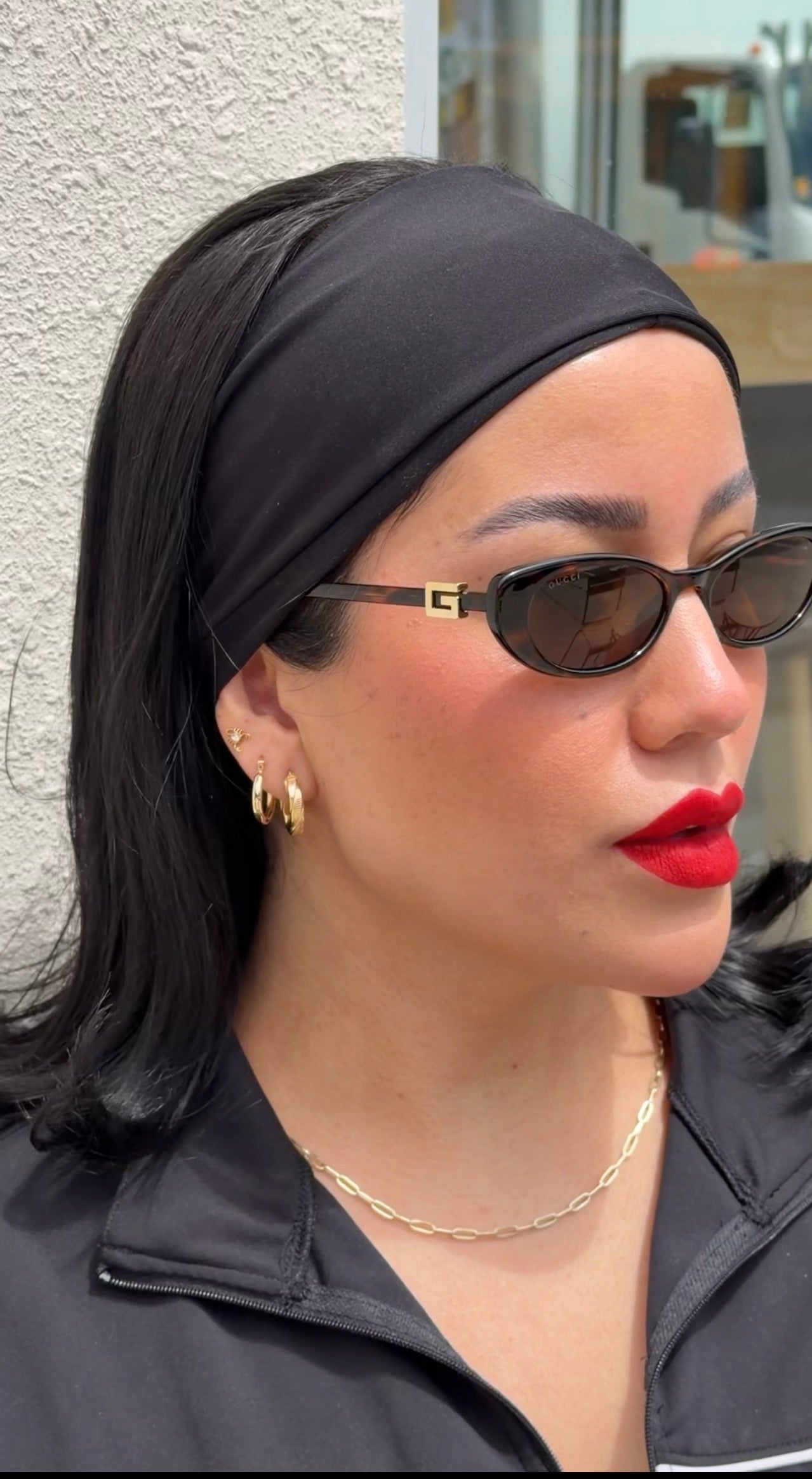 model wearing senoe twisted hoop earrings in 14k yellow gold 